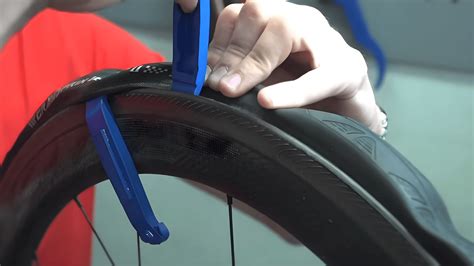 Bicycle tyre levers removing a tyre from the rim